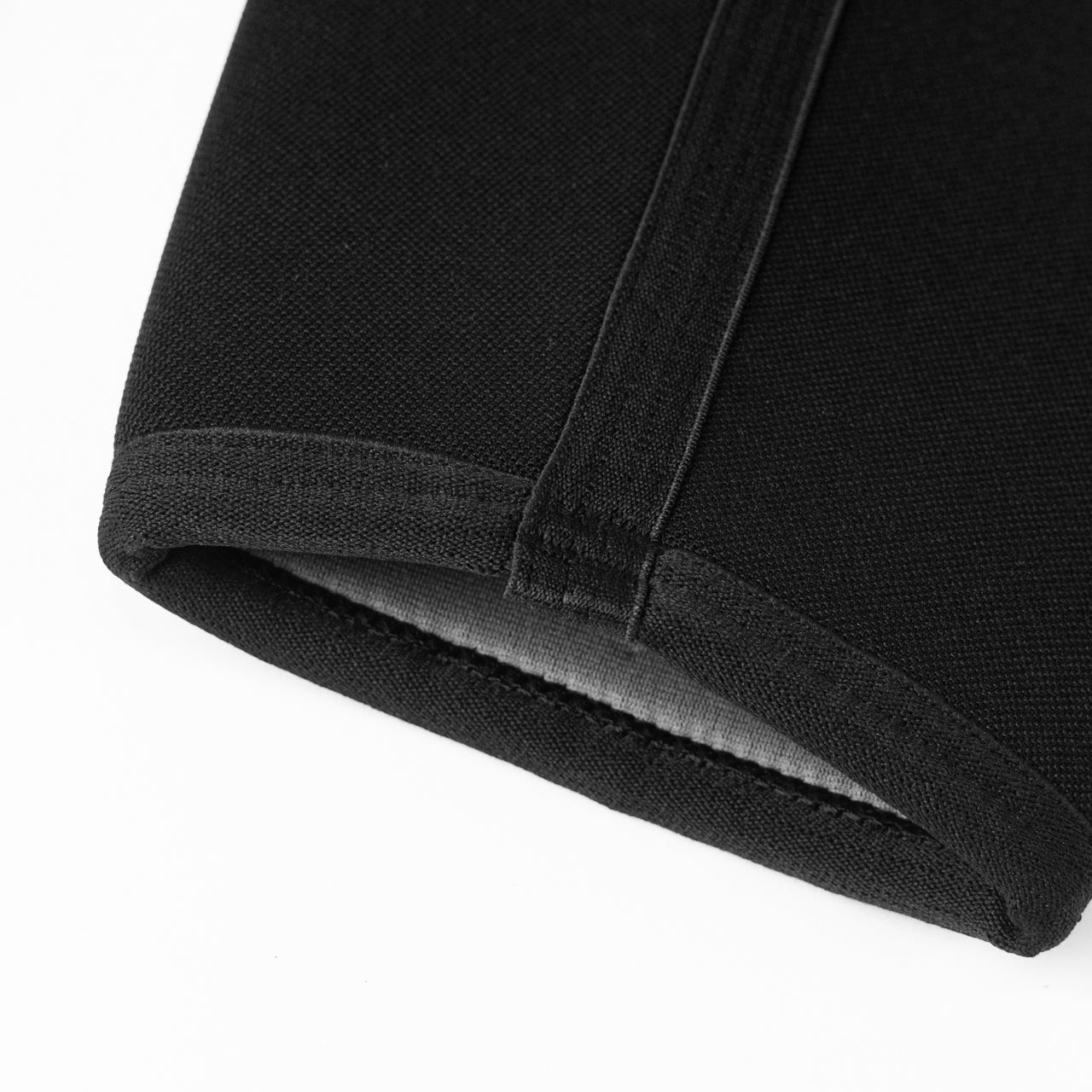 A close up of a black knee sleeve for weightlifting.