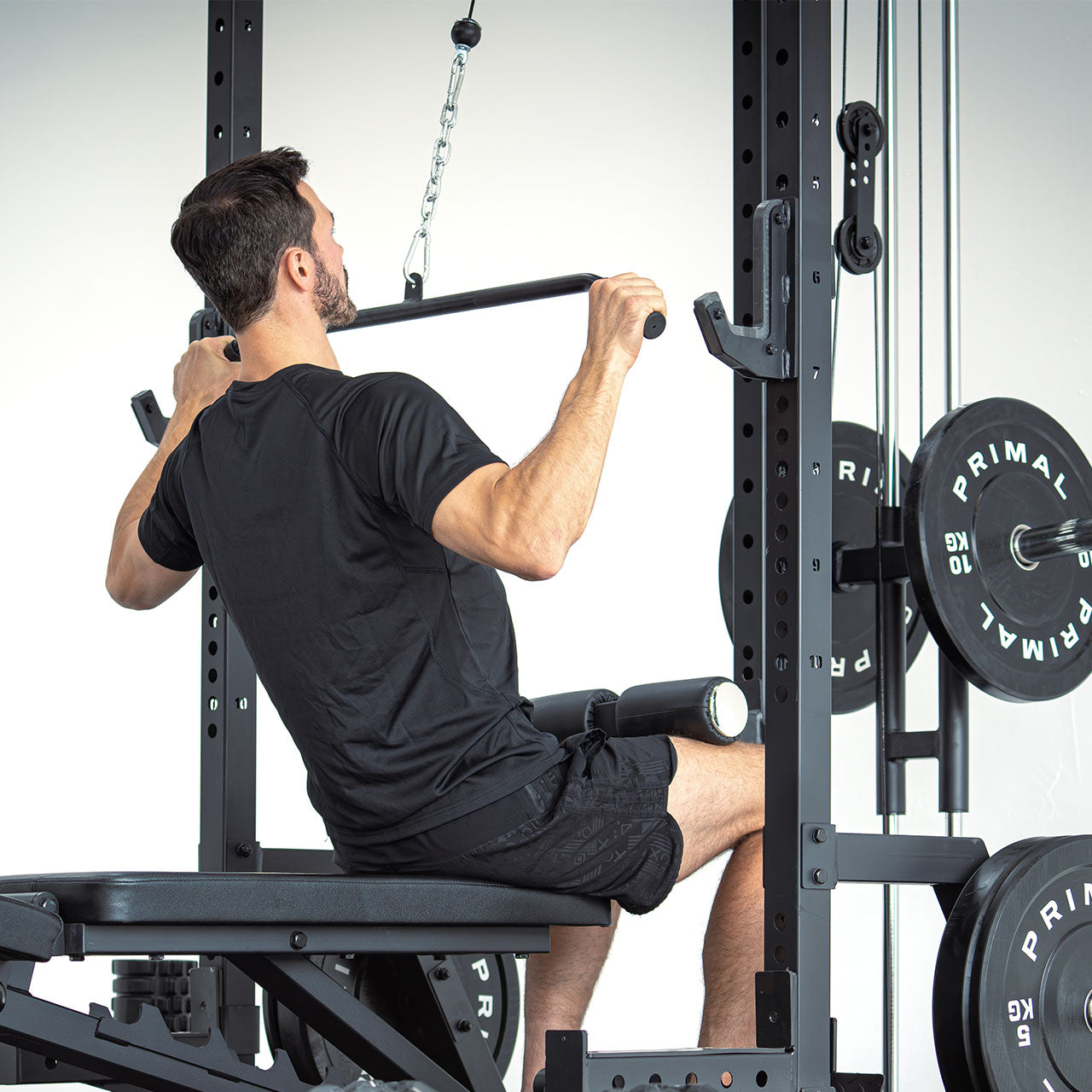 An athlete doing a lat pulldown on a half rack.