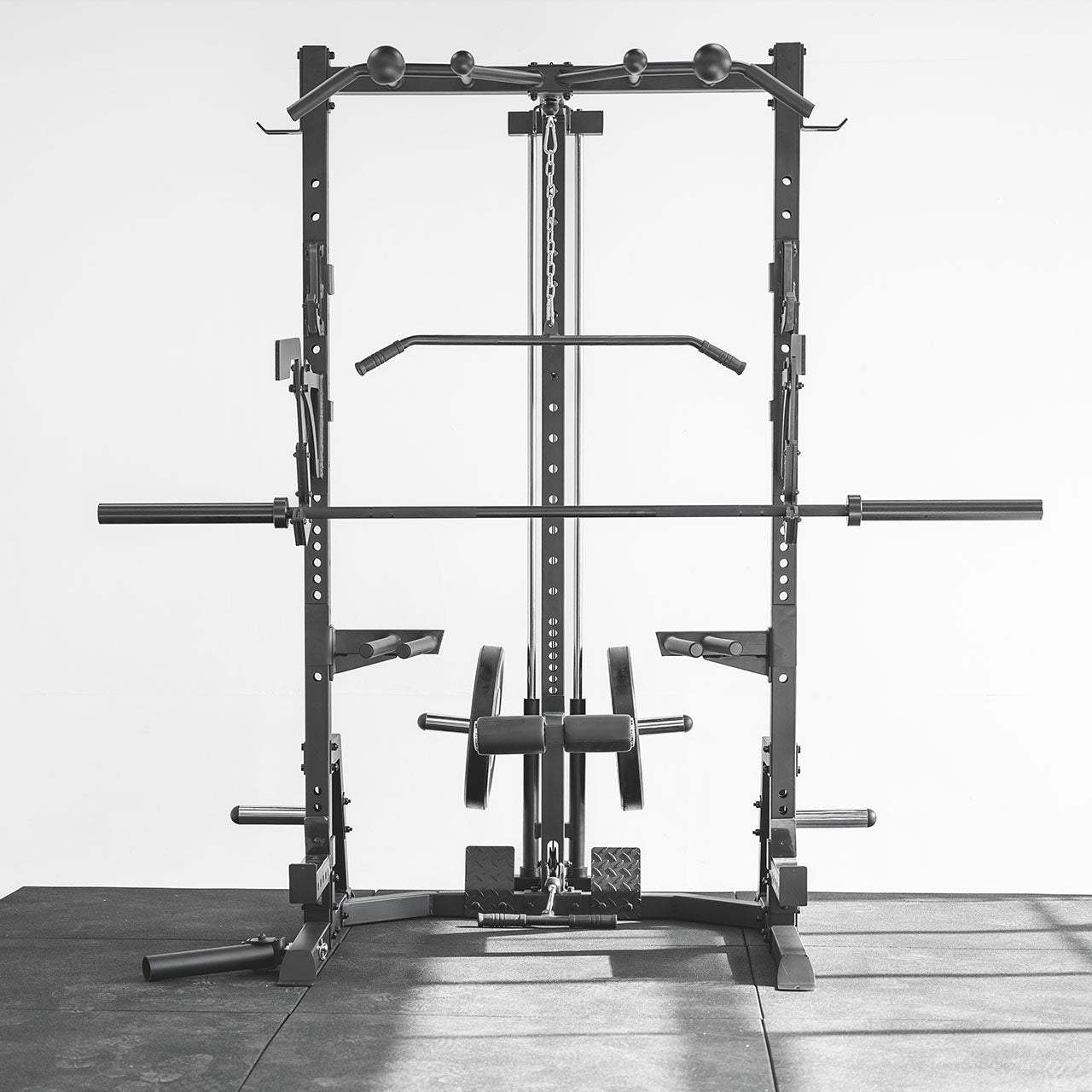 Front facing view of a half rack with barbell, bumper plates & cable attachments.