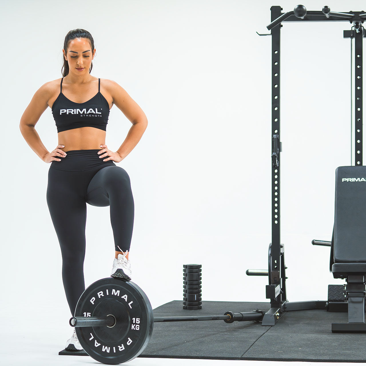 An athlete showing the landmine attachment on a half rack.