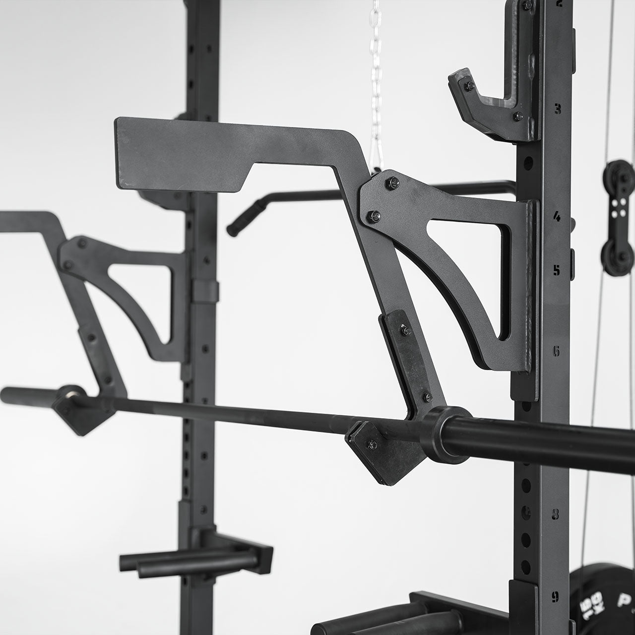 A close up of an adjustable monolift holding a barbell.